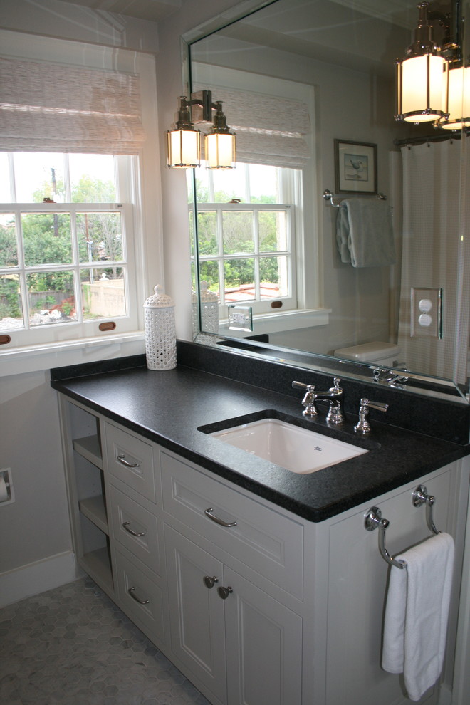 Example of a mid-sized transitional 3/4 gray tile mosaic tile floor and white floor bathroom design in Austin with recessed-panel cabinets, gray cabinets, a two-piece toilet, an undermount sink, solid surface countertops and black countertops
