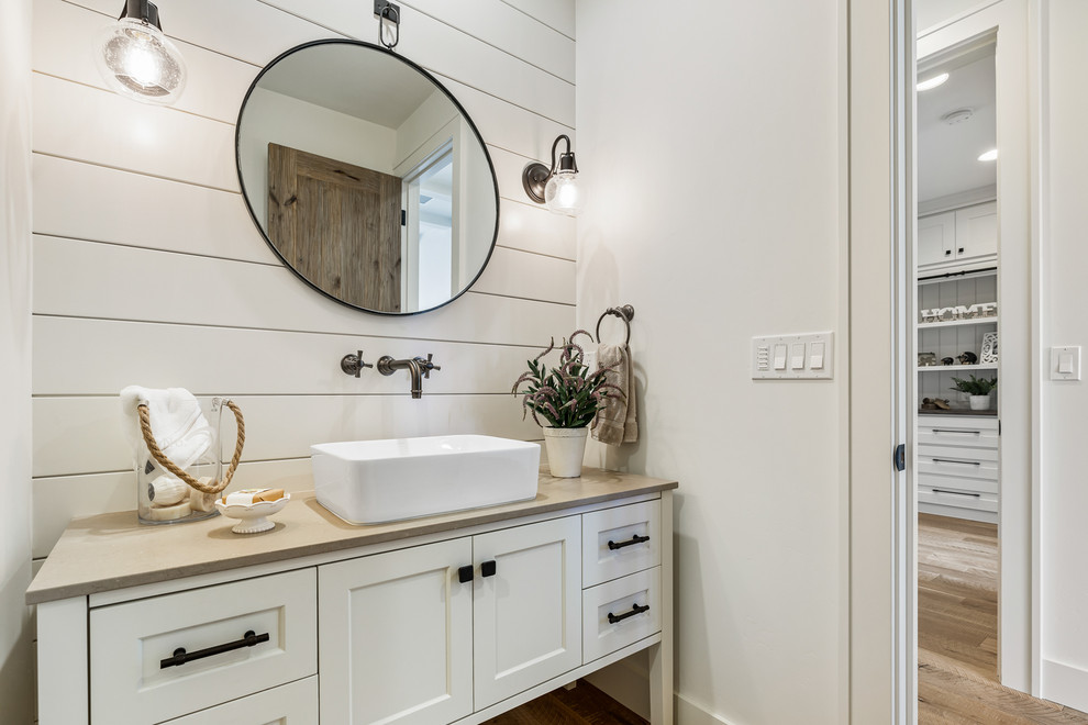 Open shower - mid-sized farmhouse 3/4 white tile medium tone wood floor and brown floor open shower idea in Other with furniture-like cabinets, gray cabinets, white walls, a vessel sink, quartz countertops and brown countertops