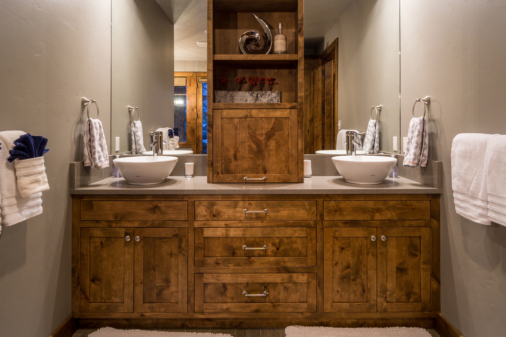 Réalisation d'une grande salle de bain principale chalet en bois brun avec un carrelage multicolore, un mur gris, un sol en carrelage de céramique, une vasque, un placard à porte affleurante et un plan de toilette en quartz.