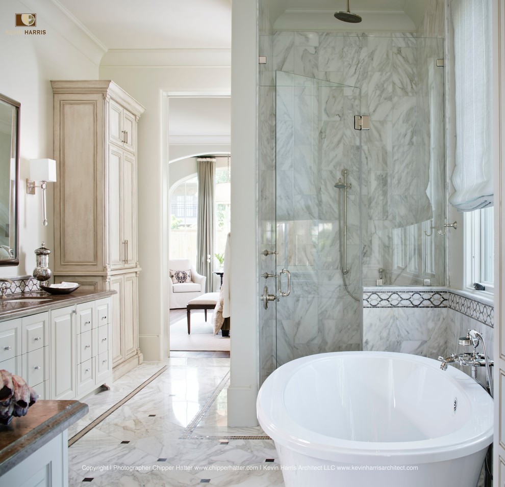 На фото: ванная комната в классическом стиле с отдельно стоящей ванной и каменной плиткой