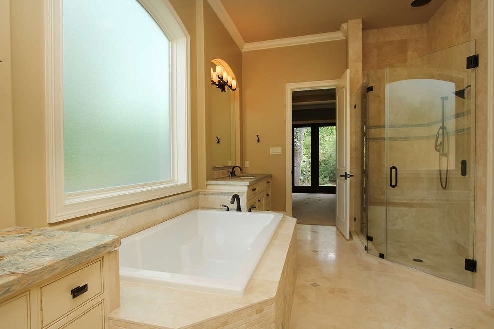 Design ideas for a large classic ensuite bathroom in Houston with beaded cabinets, white cabinets, a built-in bath, a walk-in shower, stone tiles, travertine flooring, a submerged sink and granite worktops.