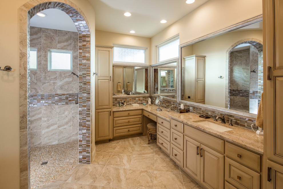 Large tuscan master multicolored tile and glass tile ceramic tile walk-in shower photo in Austin with raised-panel cabinets, distressed cabinets, beige walls, an undermount sink and granite countertops