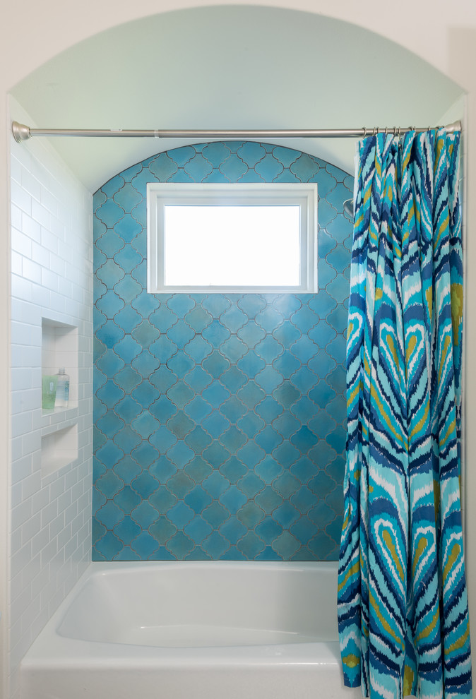Ejemplo de cuarto de baño mediterráneo de tamaño medio con bañera empotrada, combinación de ducha y bañera, baldosas y/o azulejos azules, baldosas y/o azulejos en mosaico, paredes blancas y ducha con cortina