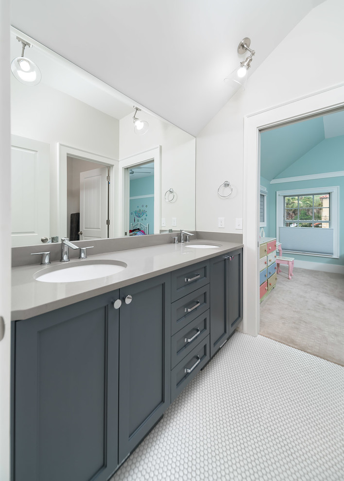 Inspiration for a small traditional family bathroom in Other with shaker cabinets, blue cabinets, an alcove shower, a two-piece toilet, grey tiles, ceramic tiles, grey walls, ceramic flooring, a submerged sink, engineered stone worktops, white floors and a hinged door.