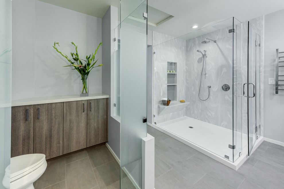 Mid-sized master ceramic tile and gray floor corner shower photo in San Francisco with flat-panel cabinets, gray cabinets, a two-piece toilet, white walls, an undermount sink, quartz countertops, a hinged shower door and white countertops
