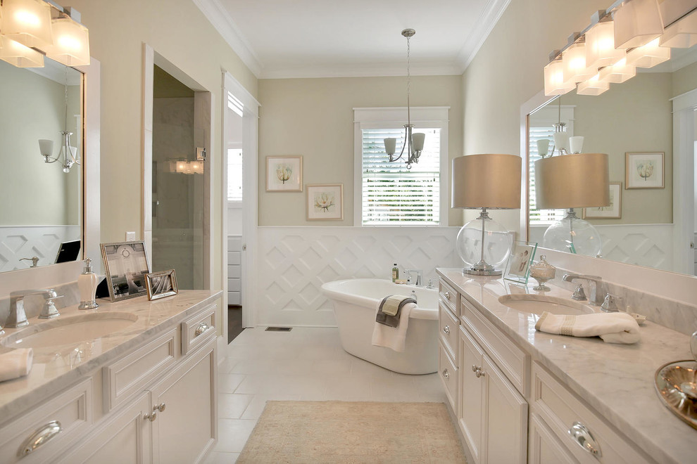 Design ideas for a medium sized classic ensuite bathroom in Richmond with a submerged sink, raised-panel cabinets, white cabinets, a freestanding bath, an alcove shower, a one-piece toilet, white tiles and beige walls.