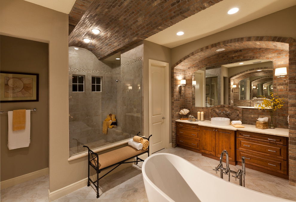 Freestanding bathtub - mediterranean freestanding bathtub idea in Tampa with a vessel sink
