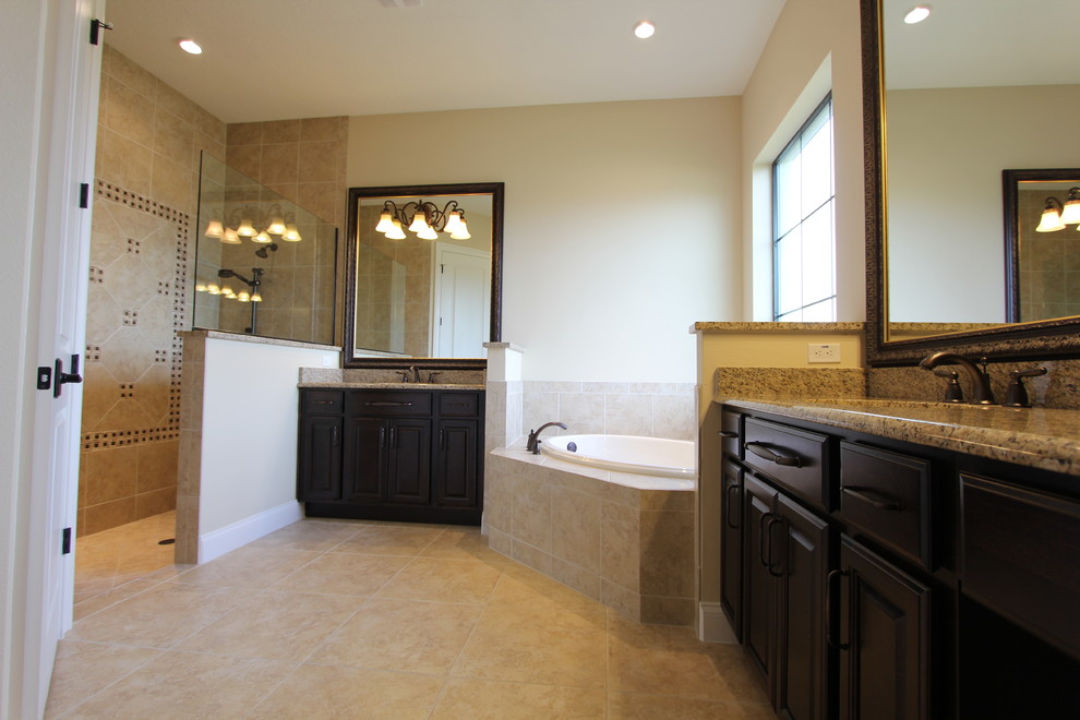 Bathroom - large transitional master beige tile and ceramic tile ceramic tile bathroom idea in Orlando with recessed-panel cabinets, dark wood cabinets, a two-piece toilet, beige walls, an undermount sink and granite countertops