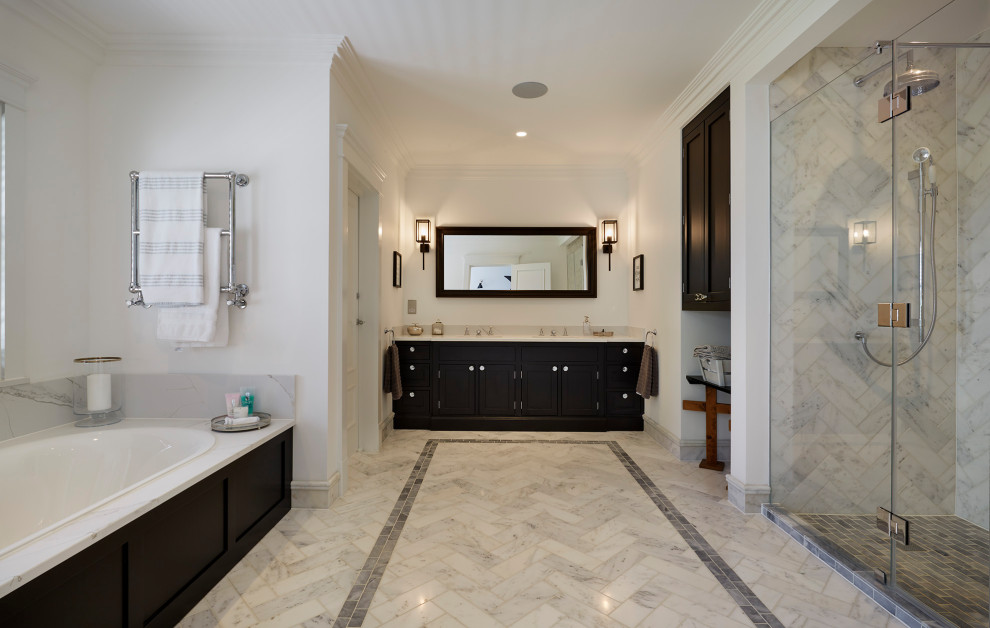 Inspiration for a coastal white tile marble floor and gray floor bathroom remodel in Hertfordshire with shaker cabinets, black cabinets, white walls, an integrated sink, quartzite countertops, a hinged shower door and white countertops