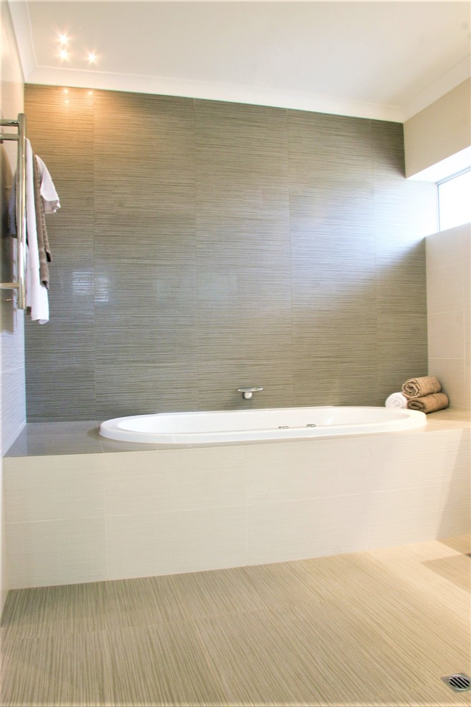 Design ideas for a large contemporary ensuite bathroom in Perth with flat-panel cabinets, white cabinets, a hot tub, a double shower, a wall mounted toilet, white tiles, porcelain tiles, white walls, porcelain flooring, a submerged sink, engineered stone worktops, grey floors and a hinged door.