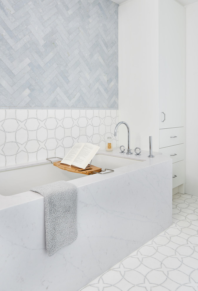 Large modern ensuite bathroom in Toronto with flat-panel cabinets, white cabinets, a submerged bath, a one-piece toilet, blue tiles, marble tiles, white walls, marble flooring, a submerged sink, engineered stone worktops, white floors and white worktops.