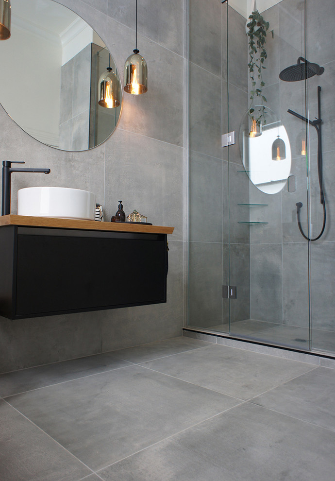 This is an example of a bathroom in Auckland with grey tiles and porcelain tiles.