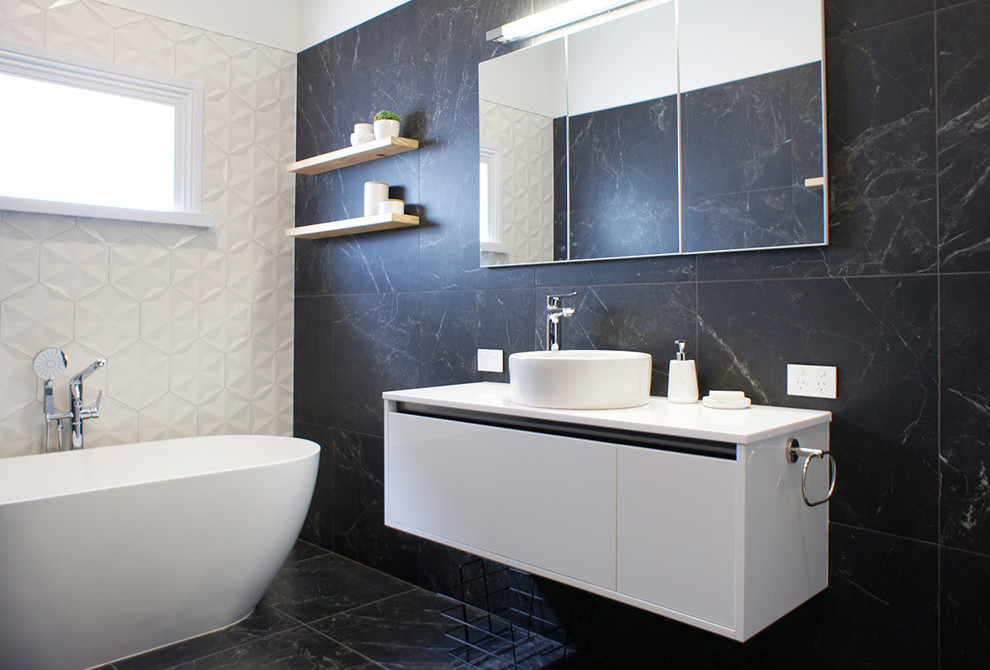 Bathroom in Auckland with black tiles and porcelain tiles.