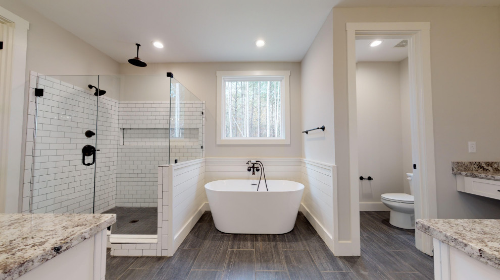 Large country master white tile and subway tile ceramic tile and gray floor bathroom photo in Atlanta with shaker cabinets, white cabinets, a two-piece toilet, gray walls, an undermount sink, granite countertops, a hinged shower door and multicolored countertops