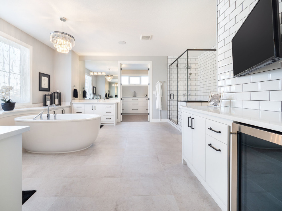 Inspiration for a classic bathroom in Calgary with flat-panel cabinets, white cabinets, a freestanding bath, white tiles, metro tiles, grey walls, beige floors and white worktops.