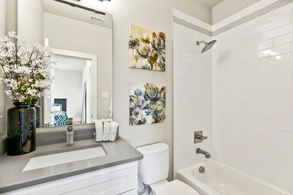 This is an example of a modern family bathroom in Dallas with white cabinets, grey tiles, metro tiles, grey walls, ceramic flooring, granite worktops, beige floors, a shower curtain and grey worktops.