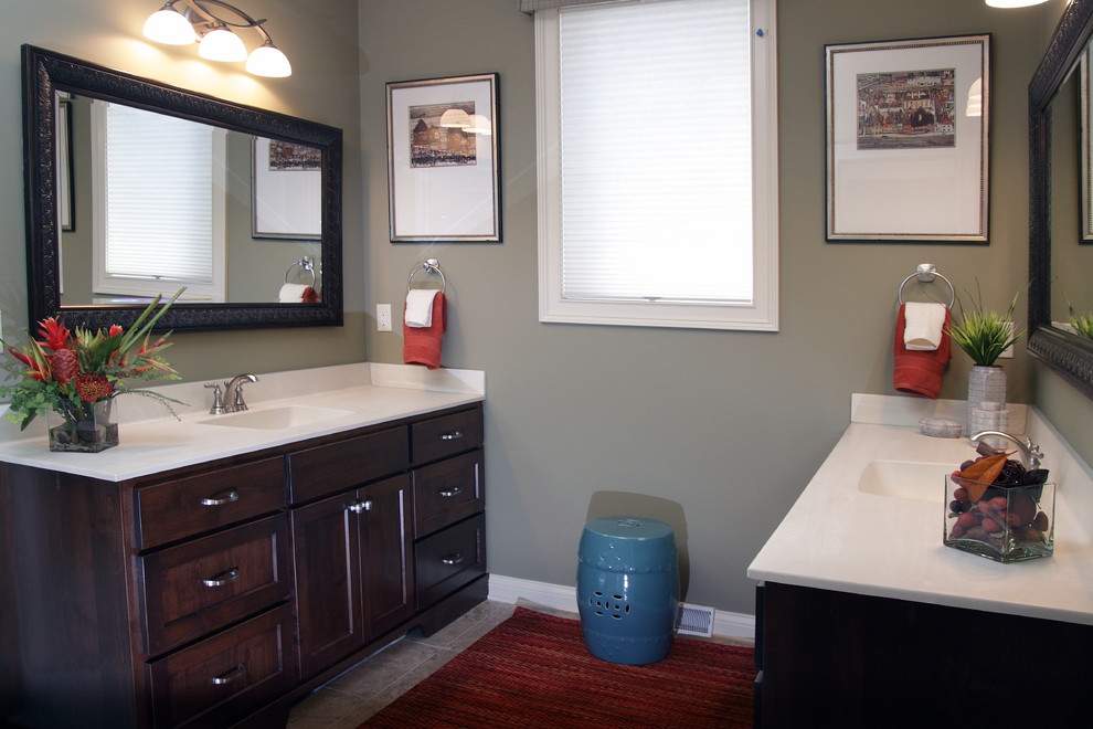 This is an example of a classic ensuite bathroom in Milwaukee with a built-in sink, recessed-panel cabinets, dark wood cabinets, marble worktops, grey tiles, ceramic tiles, grey walls and ceramic flooring.