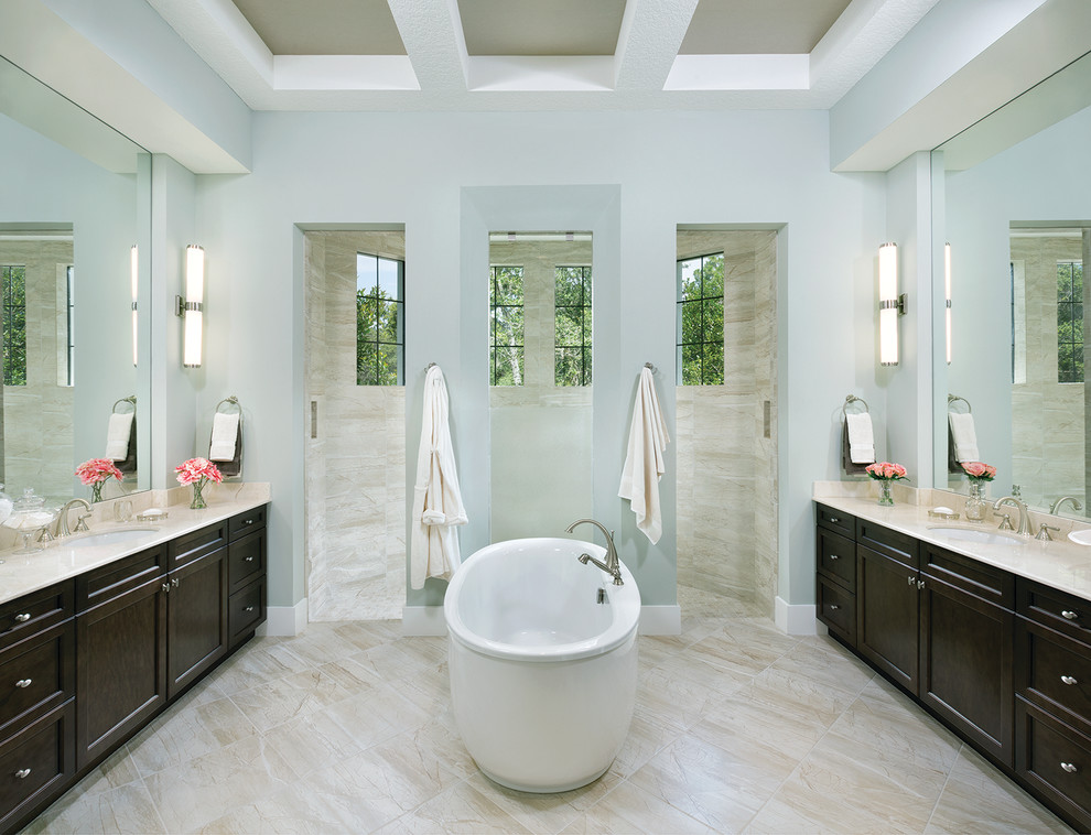 Freestanding bathtub - huge contemporary master white tile and stone tile marble floor freestanding bathtub idea in Tampa with an undermount sink, recessed-panel cabinets, dark wood cabinets, marble countertops, a one-piece toilet and gray walls