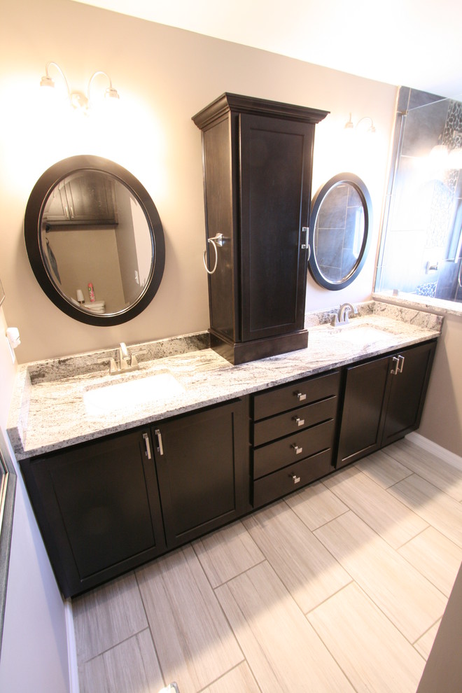 Design ideas for a contemporary ensuite bathroom in Jacksonville with shaker cabinets, dark wood cabinets, a walk-in shower, pebble tiles, beige walls, ceramic flooring, a submerged sink and soapstone worktops.