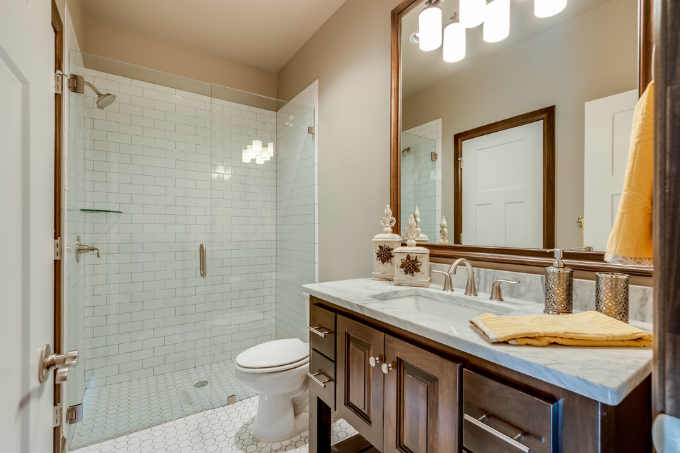 Exempel på ett mellanstort klassiskt badrum med dusch, med luckor med upphöjd panel, ett badkar i en alkov, keramikplattor, beige väggar, ett undermonterad handfat, skåp i mörkt trä, en dusch i en alkov, en toalettstol med separat cisternkåpa, vit kakel, mosaikgolv, marmorbänkskiva, vitt golv och dusch med gångjärnsdörr