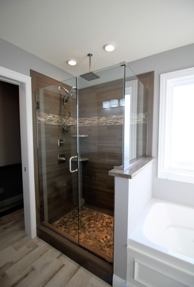 Photo of a traditional bathroom in Other with a walk-in shower, beige tiles, ceramic tiles, brown walls and pebble tile flooring.