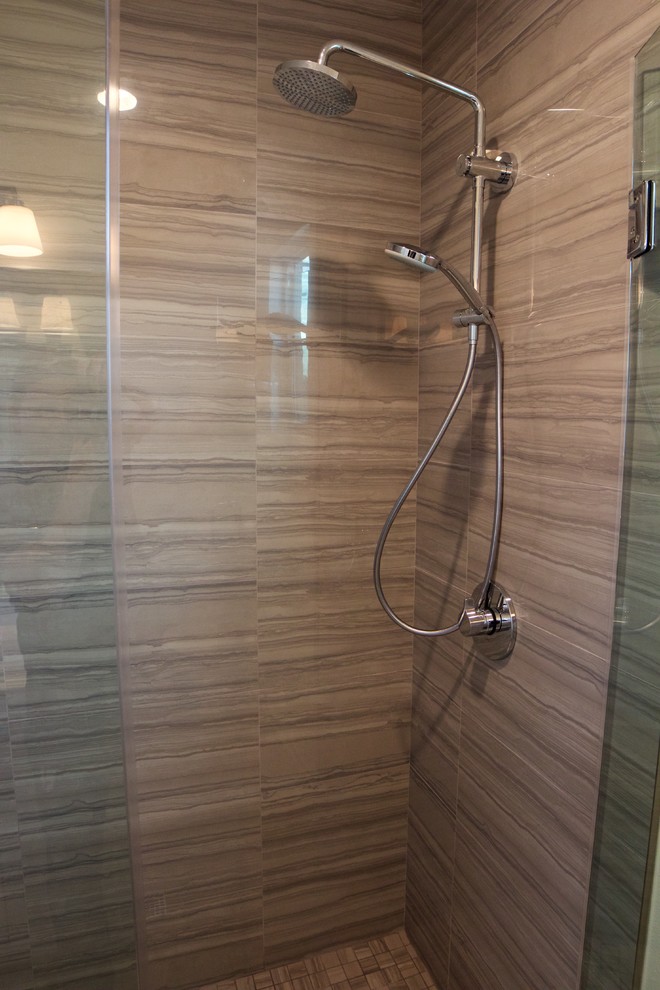 This is an example of a small modern shower room bathroom in Orange County with shaker cabinets, white cabinets, an alcove shower, a two-piece toilet, brown tiles, porcelain tiles, white walls, a submerged sink, quartz worktops, a hinged door and white worktops.