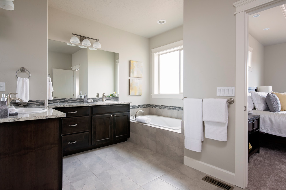 Mid-sized transitional master black and white tile, gray tile and matchstick tile ceramic tile drop-in bathtub photo in Boise with shaker cabinets, dark wood cabinets, gray walls, a drop-in sink and quartz countertops