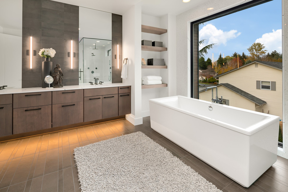 Freestanding bathtub - large contemporary master gray tile gray floor freestanding bathtub idea in Seattle with flat-panel cabinets, gray cabinets, white walls, an undermount sink, quartz countertops and white countertops