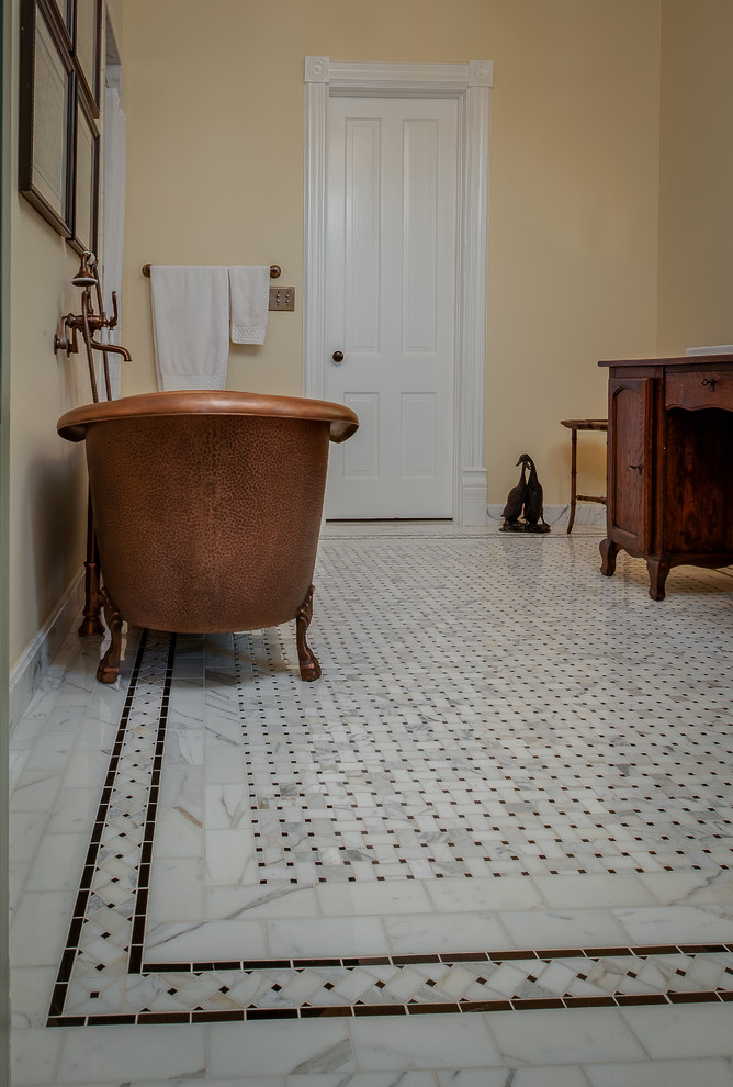 Medium sized bohemian ensuite bathroom in Other with a claw-foot bath, an alcove shower, a two-piece toilet, multi-coloured tiles, stone tiles, yellow walls, mosaic tile flooring, a built-in sink, marble worktops, recessed-panel cabinets and dark wood cabinets.