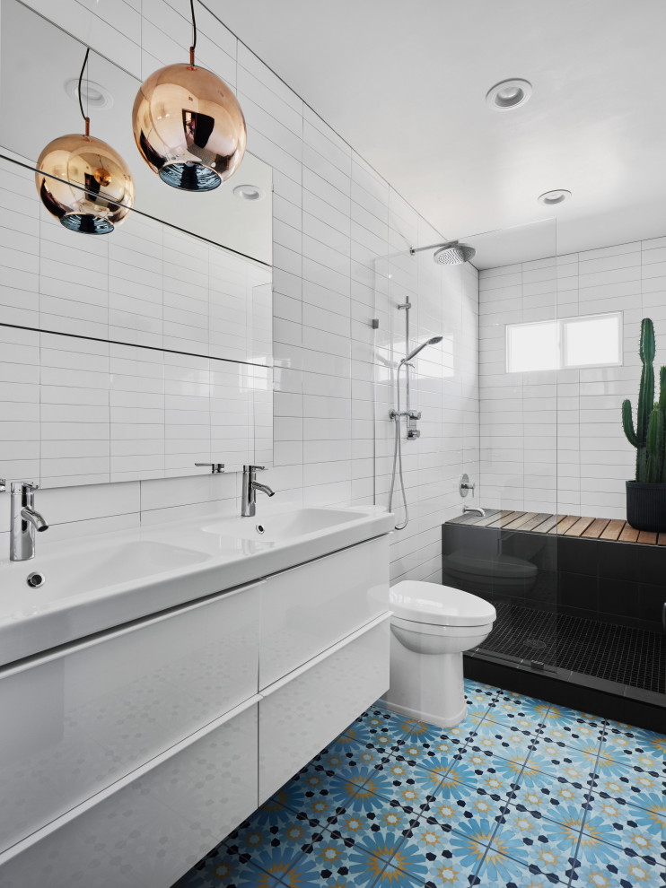 Bathroom - large contemporary 3/4 white tile blue floor and double-sink bathroom idea in Phoenix with flat-panel cabinets, white cabinets, an integrated sink, white countertops and a floating vanity