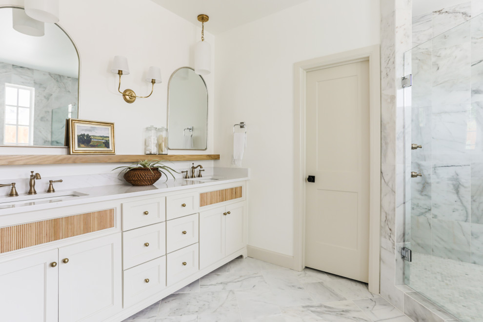 Example of a mid-sized transitional master white tile and marble tile light wood floor, white floor and double-sink bathroom design in Oklahoma City with shaker cabinets, beige cabinets, a one-piece toilet, white walls, an undermount sink, quartz countertops, a hinged shower door, white countertops and a built-in vanity