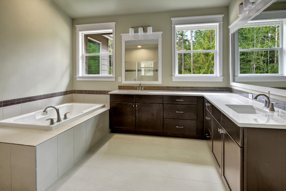 This is an example of a classic ensuite bathroom in Seattle with a submerged sink, shaker cabinets, dark wood cabinets, engineered stone worktops, a built-in bath, beige tiles, ceramic tiles, beige walls and ceramic flooring.
