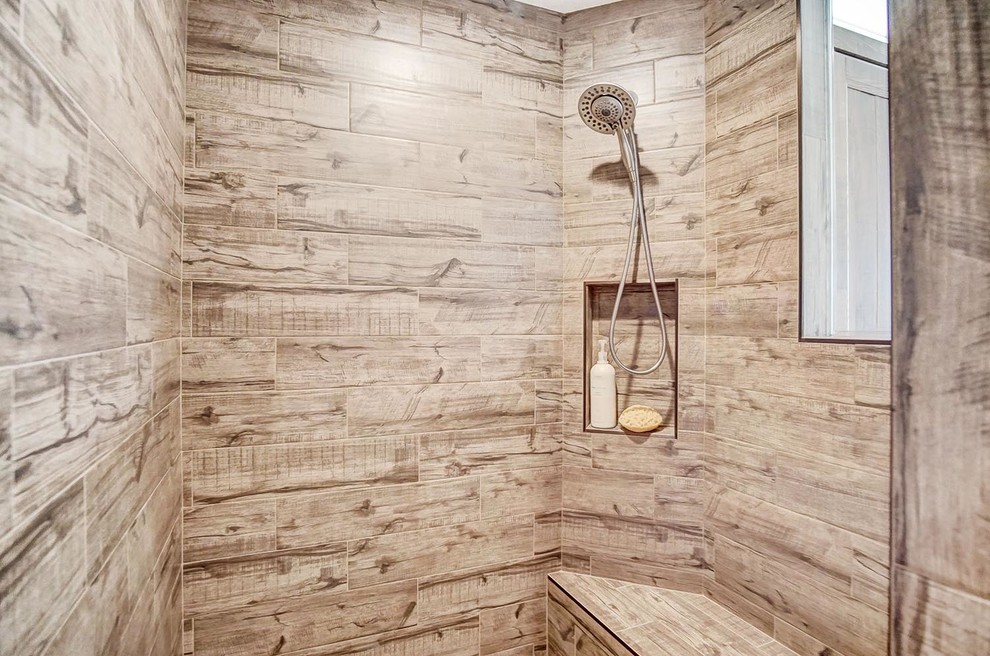 This is an example of a large rustic ensuite bathroom in Other with shaker cabinets, distressed cabinets, a walk-in shower, a one-piece toilet, brown tiles, ceramic tiles, beige walls, ceramic flooring, a submerged sink, quartz worktops, brown floors, an open shower and black worktops.