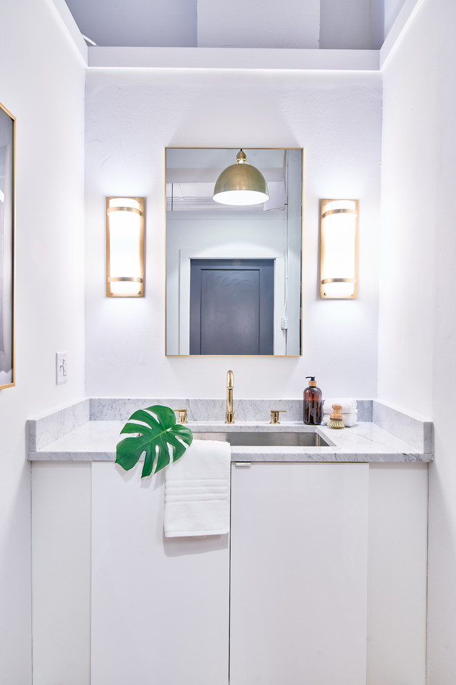 Medium sized scandinavian ensuite bathroom in Providence with flat-panel cabinets, white cabinets, white tiles, metro tiles, white walls, ceramic flooring, a submerged sink, engineered stone worktops, white floors and white worktops.