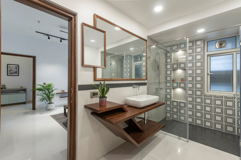 Contemporary shower room bathroom in Delhi with open cabinets, dark wood cabinets, a built-in shower, black and white tiles, white walls, a vessel sink, wooden worktops, white floors, a hinged door, brown worktops, a wall niche, a single sink and a floating vanity unit.