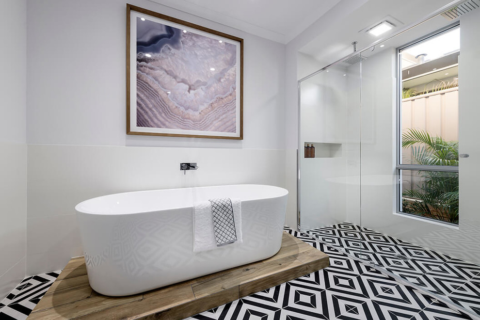 Design ideas for a large contemporary ensuite bathroom in Perth with flat-panel cabinets, black cabinets, a freestanding bath, a double shower, white tiles, white walls, porcelain flooring, engineered stone worktops, a hinged door and black floors.