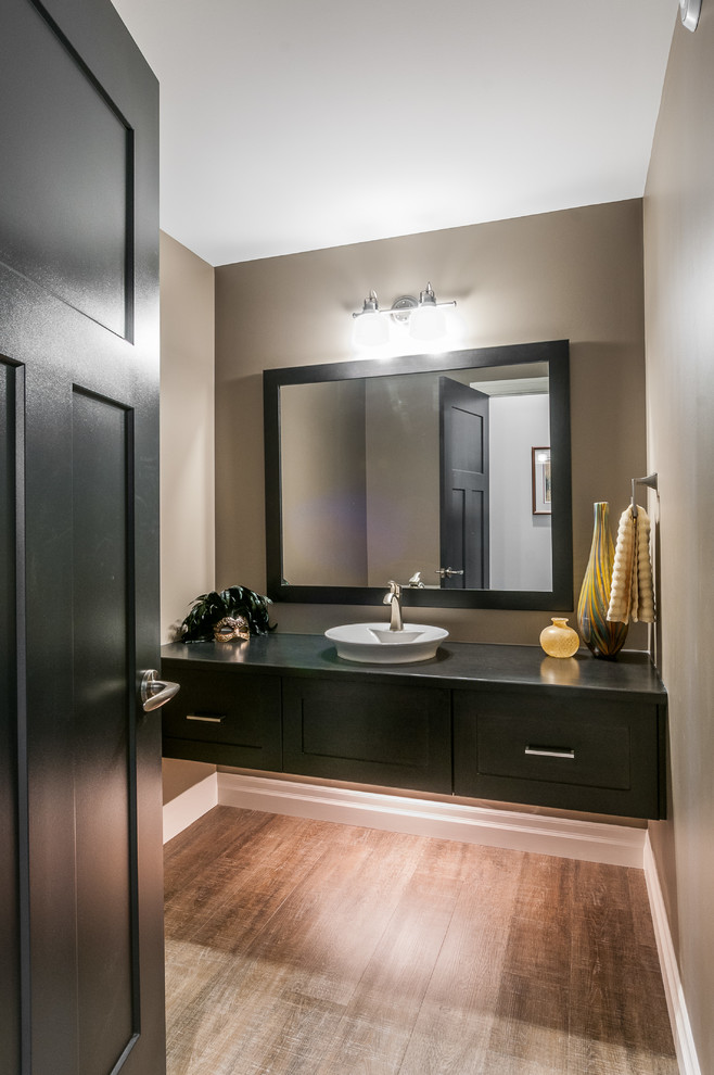 Photo of a large classic shower room bathroom in Toronto with a vessel sink, shaker cabinets, dark wood cabinets, wooden worktops, a two-piece toilet, black tiles, beige walls and dark hardwood flooring.