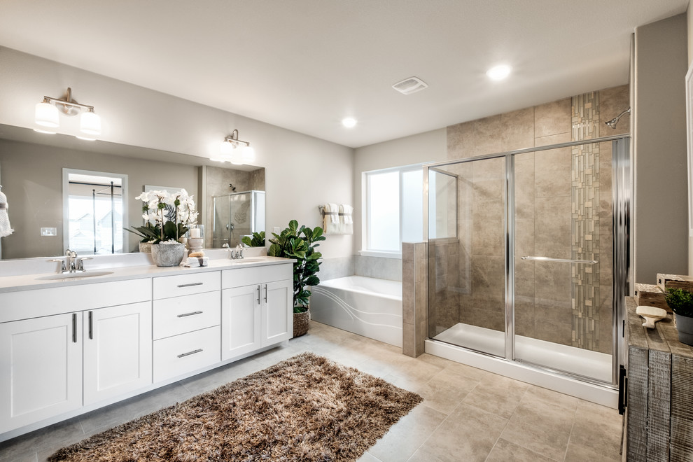 Photo of a large vintage ensuite bathroom in Seattle with beaded cabinets, white cabinets, an alcove bath, an alcove shower, a one-piece toilet, beige tiles, ceramic tiles, grey walls, cement flooring, a submerged sink, quartz worktops, beige floors, a sliding door and white worktops.