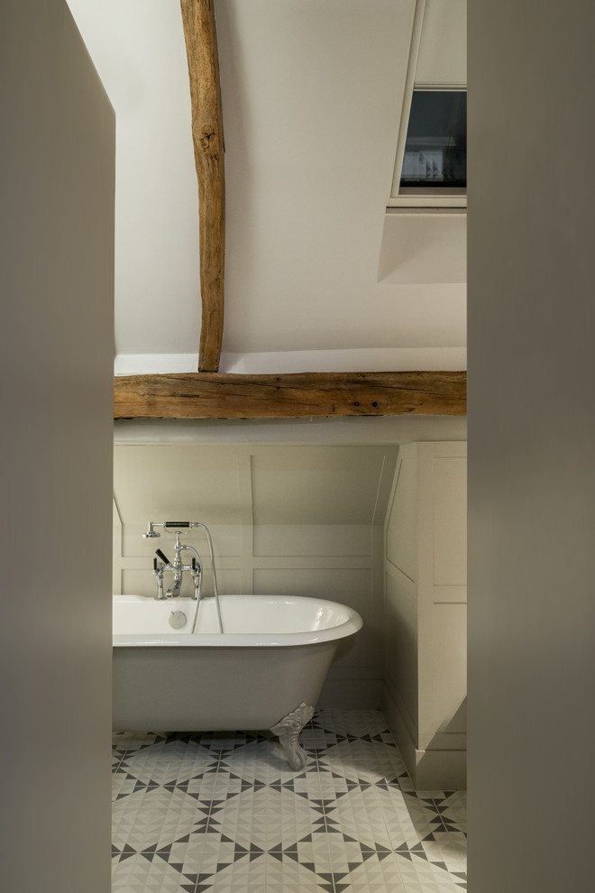 This is an example of a medium sized rural family bathroom in Buckinghamshire with flat-panel cabinets, ceramic tiles, solid surface worktops, a claw-foot bath, grey walls, ceramic flooring and multi-coloured floors.