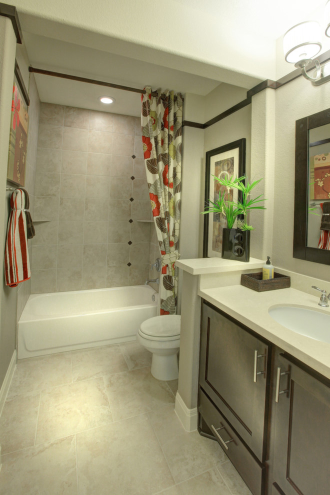 Example of a mid-sized transitional beige tile and ceramic tile ceramic tile bathroom design in Austin with an undermount sink, brown cabinets, quartz countertops and beige walls