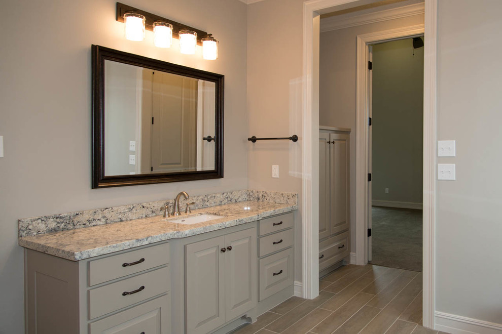 This is an example of a large country ensuite bathroom in Houston.