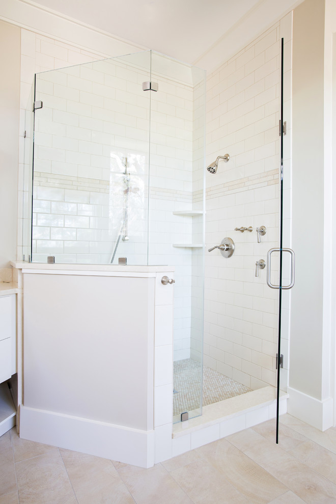 Example of a large classic master white tile and subway tile porcelain tile and beige floor bathroom design in Charleston with flat-panel cabinets, white cabinets, beige walls, an undermount sink, quartz countertops, a hinged shower door and beige countertops