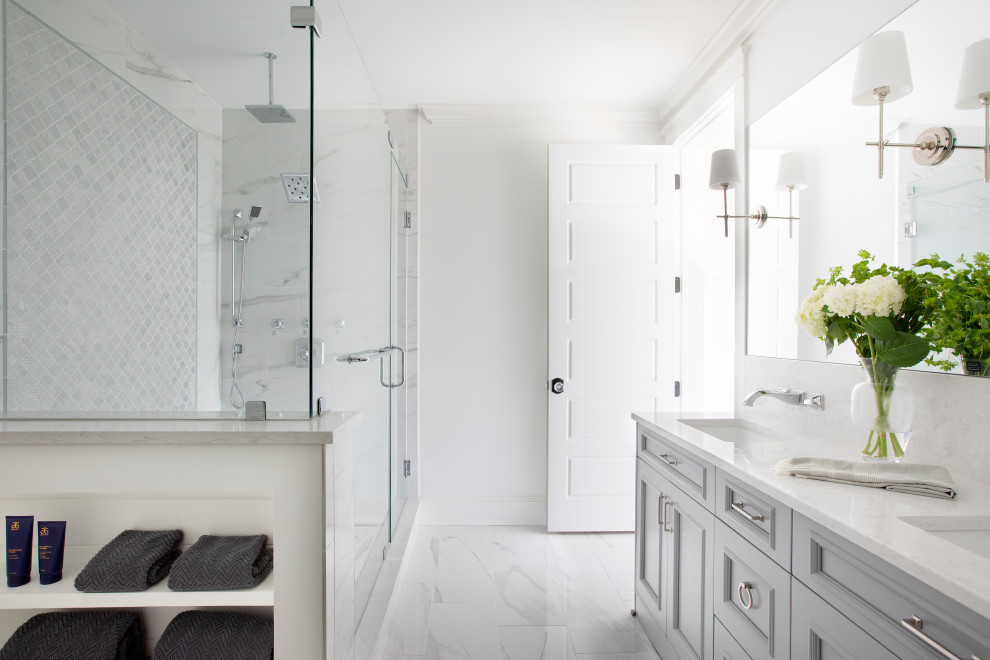 Beach style white tile gray floor and double-sink double shower photo in Charleston with recessed-panel cabinets, an undermount sink, a hinged shower door, white countertops and a built-in vanity