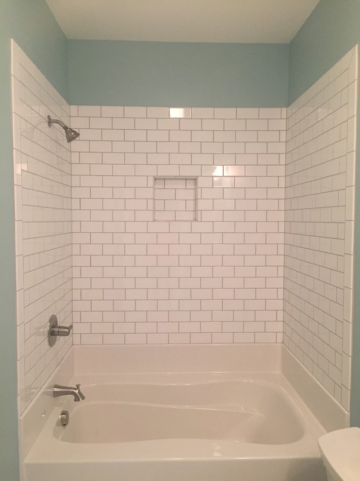 Bathroom - craftsman kids' white tile and ceramic tile ceramic tile bathroom idea in Charlotte with shaker cabinets, white cabinets, a one-piece toilet, an undermount sink, granite countertops and blue walls