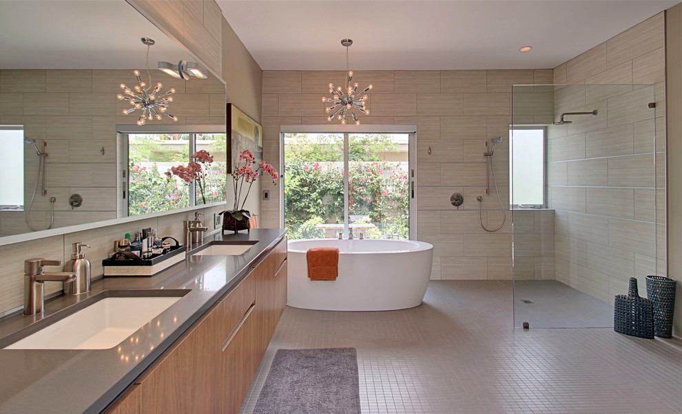 This is an example of a large retro bathroom in Other with flat-panel cabinets, light wood cabinets, a freestanding bath, a walk-in shower, a one-piece toilet, beige tiles and beige walls.