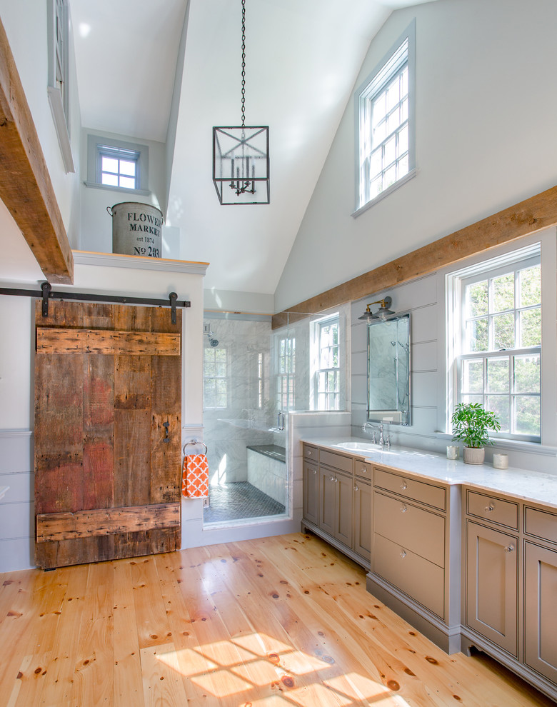 Example of a large country master white tile and porcelain tile light wood floor alcove shower design in Boston with a drop-in sink, gray cabinets, marble countertops, gray walls and beaded inset cabinets