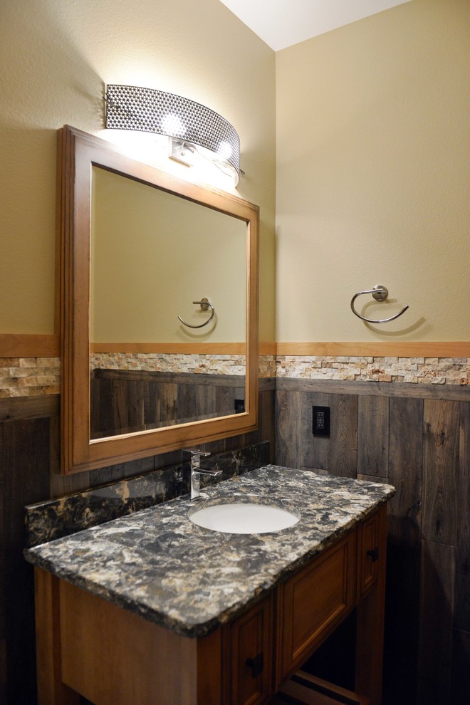 Example of a mid-sized classic 3/4 multicolored tile and stone tile vinyl floor bathroom design in Other with shaker cabinets, beige cabinets, a one-piece toilet, beige walls, an undermount sink and granite countertops