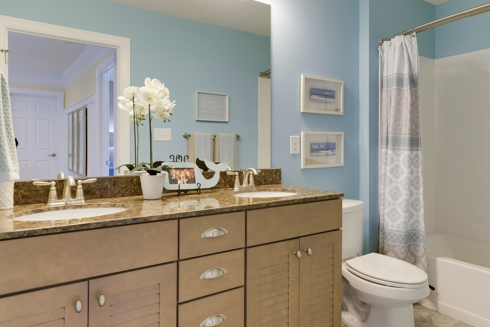 Mid-sized beach style kids' white tile and ceramic tile ceramic tile and gray floor bathroom photo in Philadelphia with louvered cabinets, brown cabinets, a two-piece toilet, blue walls, a drop-in sink and quartz countertops