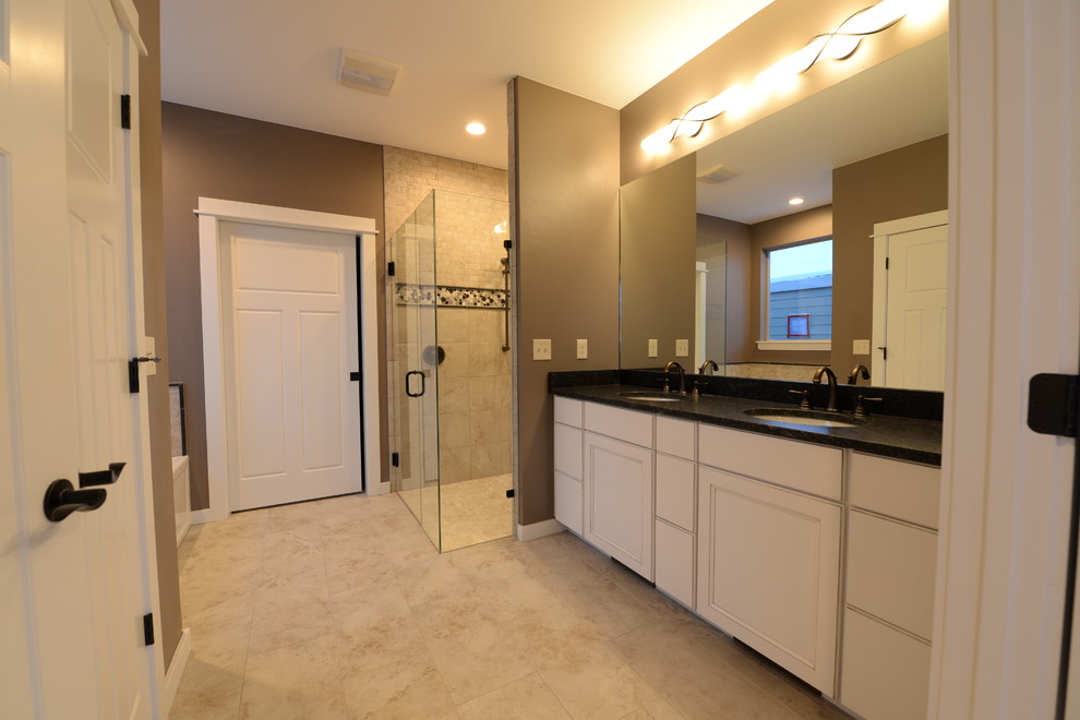 Inspiration for a mid-sized contemporary master beige tile and stone tile porcelain tile walk-in shower remodel in Other with an undermount sink, shaker cabinets, white cabinets, granite countertops and gray walls