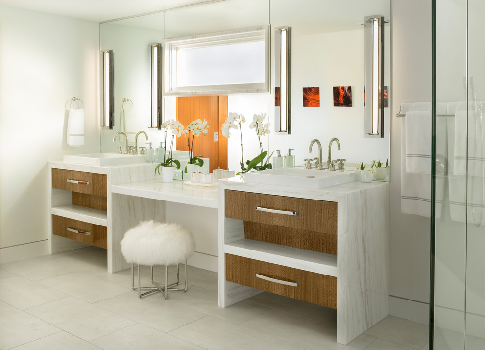 Example of a large trendy master multicolored tile and stone slab porcelain tile and white floor bathroom design in Other with flat-panel cabinets, light wood cabinets, white walls, a vessel sink, marble countertops, a hinged shower door and white countertops